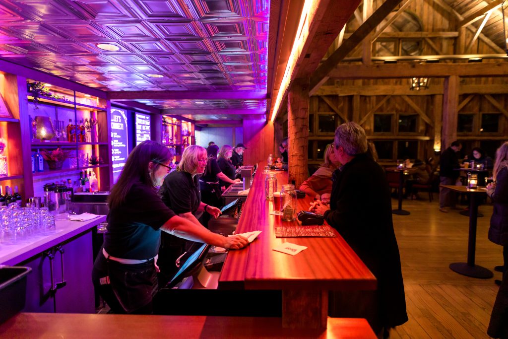 Patrons order drinks in the Scottish Barn before the show.