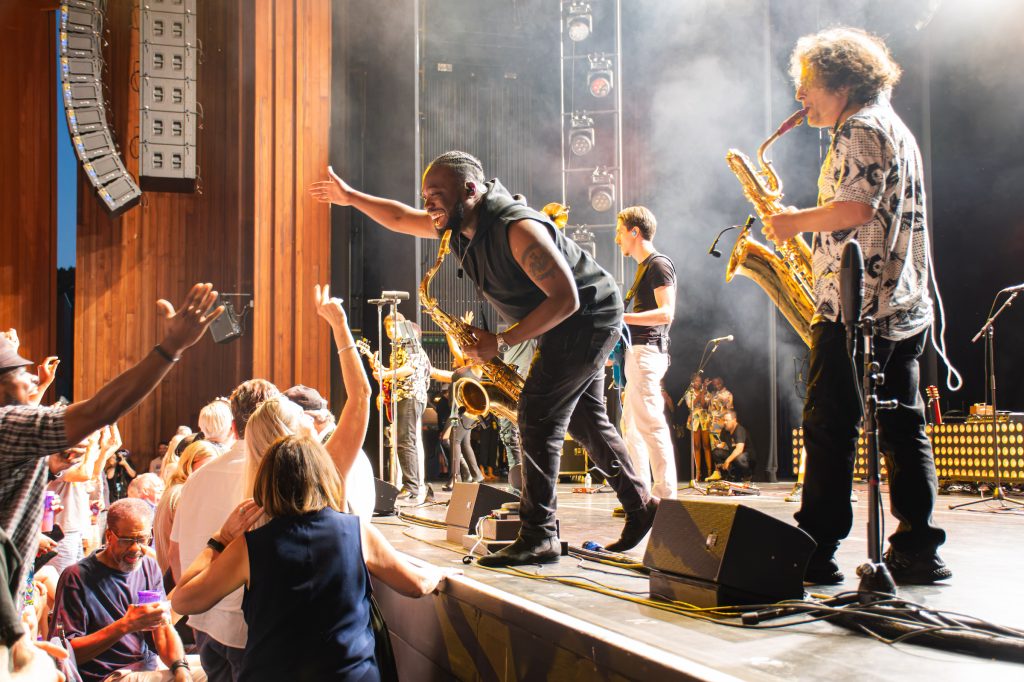 Trombone Shorty & Orleans Avenue with fans in the front row. 